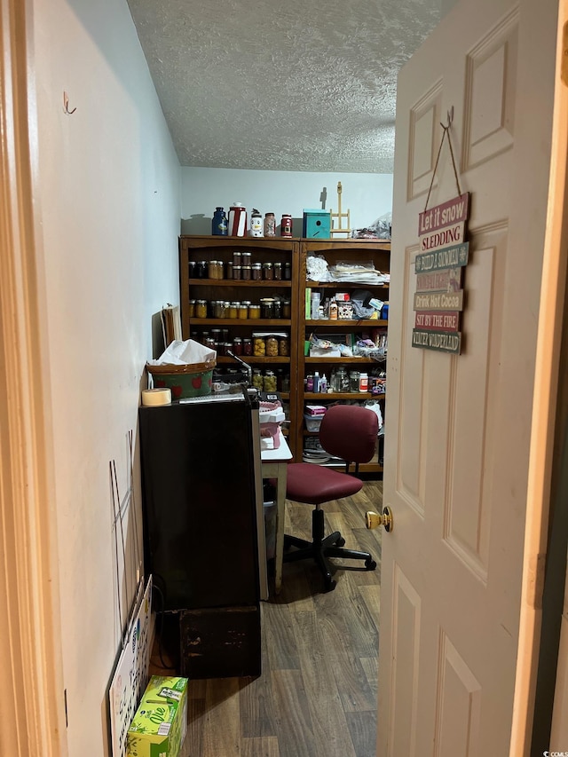 office area with wood-type flooring and a textured ceiling