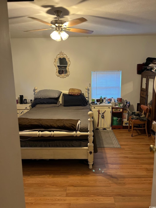 bedroom featuring ceiling fan and light hardwood / wood-style flooring