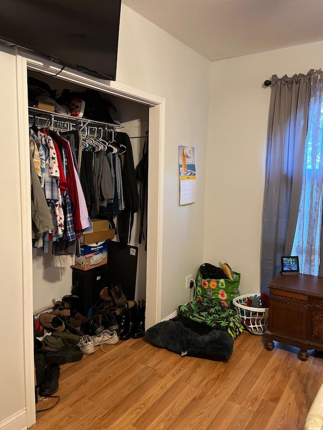 bedroom featuring hardwood / wood-style floors and a closet