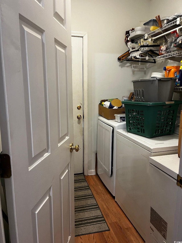 washroom with washer and dryer and dark hardwood / wood-style flooring