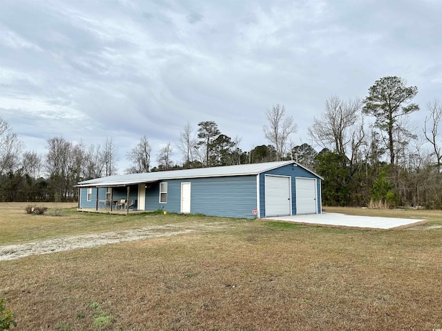 exterior space with a garage, a porch, and a yard