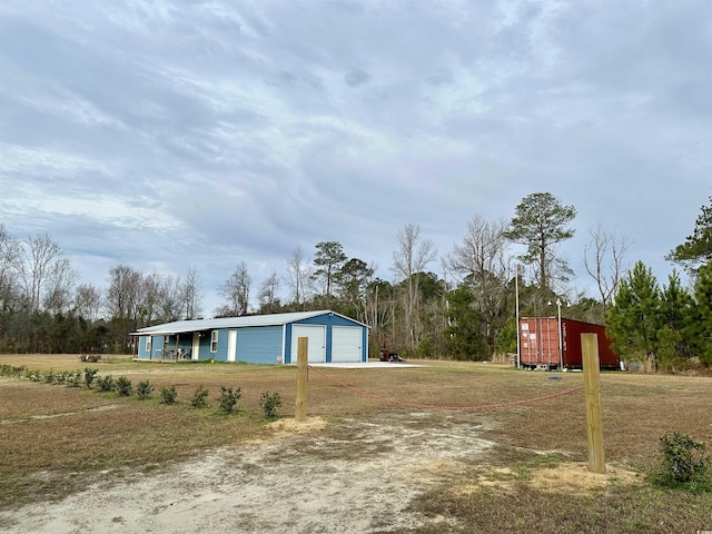 view of property exterior featuring a garage and a yard