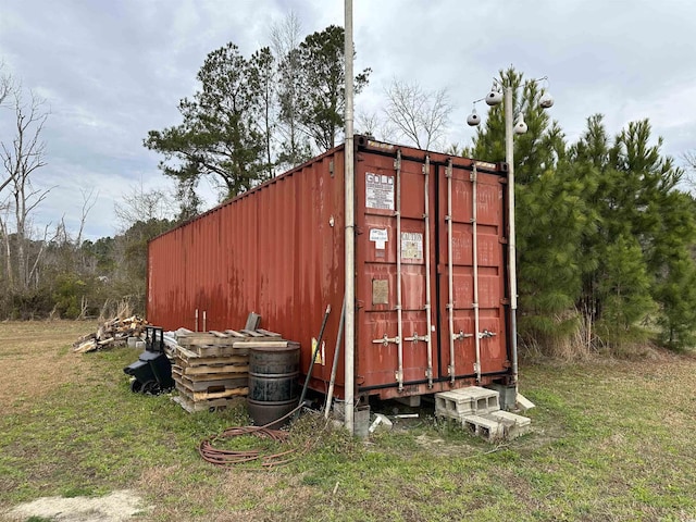 view of outbuilding with a yard