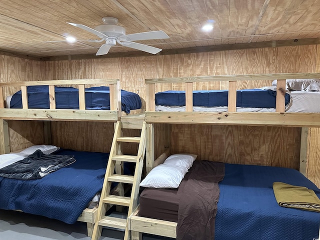 bedroom featuring wood ceiling and wooden walls