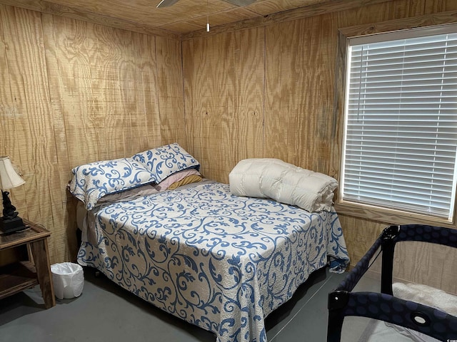 bedroom featuring wooden walls