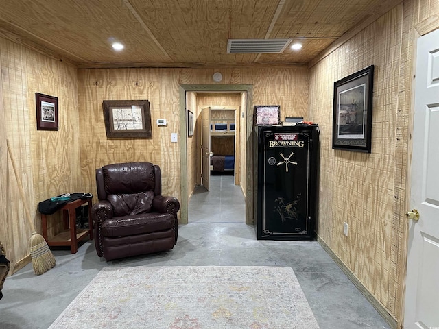 living area with wooden walls and wooden ceiling