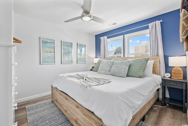 bedroom with ceiling fan and dark wood-type flooring