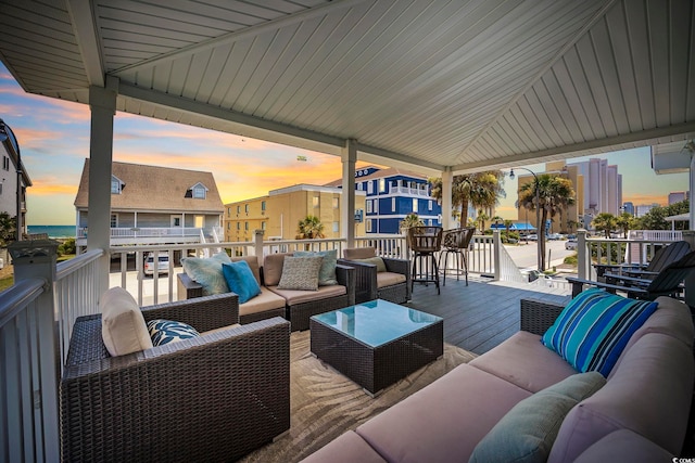 deck at dusk featuring an outdoor hangout area