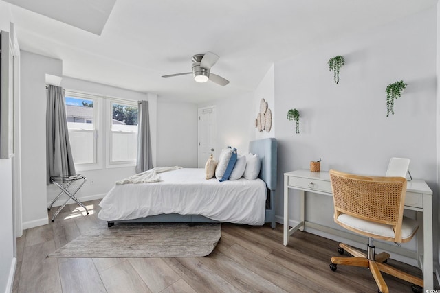 bedroom with ceiling fan and light hardwood / wood-style floors