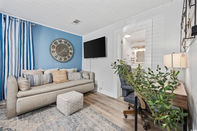 living room with wood ceiling, crown molding, and wood-type flooring