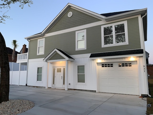 view of front of property with an attached garage, board and batten siding, and concrete driveway