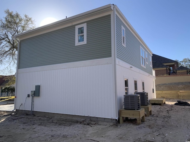 view of side of home featuring fence and central air condition unit