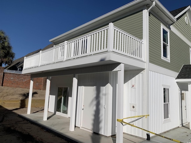 rear view of property with a patio and a balcony