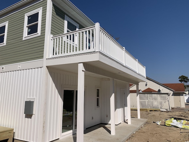 rear view of property with a balcony and a patio