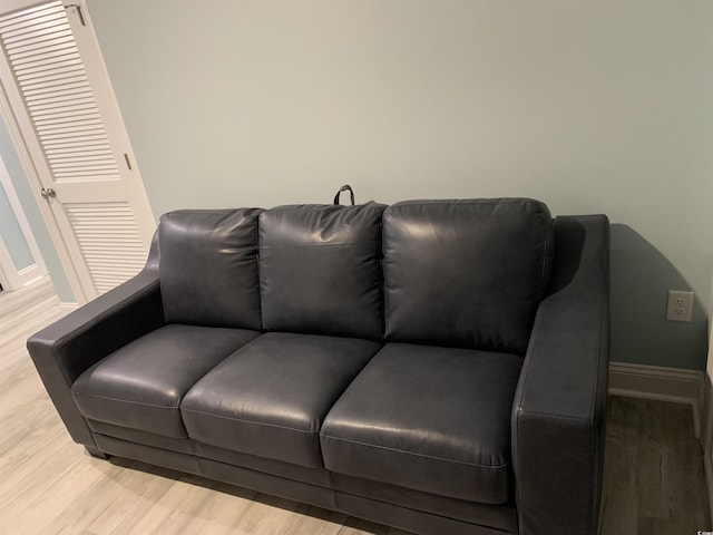 sitting room with baseboards and wood finished floors