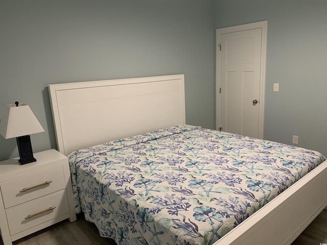 bedroom with dark wood-style flooring