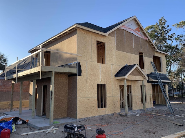 exterior space featuring a shingled roof, a patio, a balcony, and stucco siding