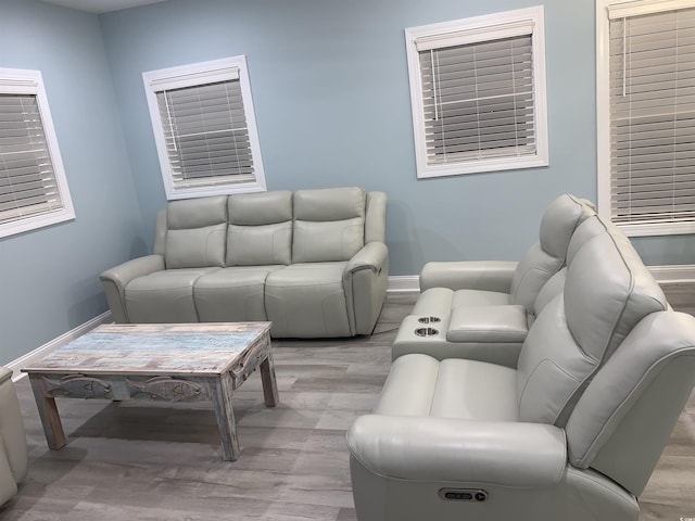 living room with light wood-type flooring and baseboards