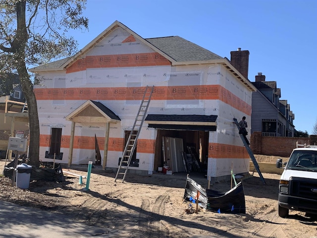 property under construction featuring roof with shingles