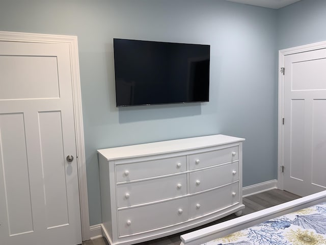 interior details featuring wood finished floors and baseboards