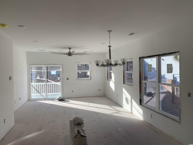 empty room featuring visible vents and ceiling fan with notable chandelier