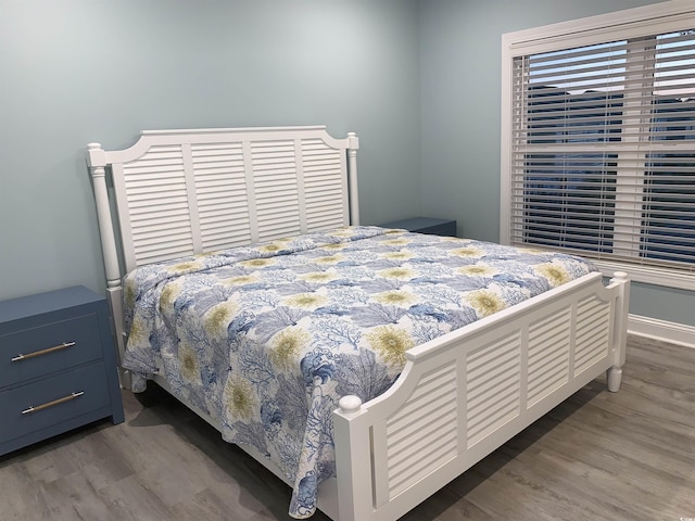 bedroom featuring baseboards and wood finished floors