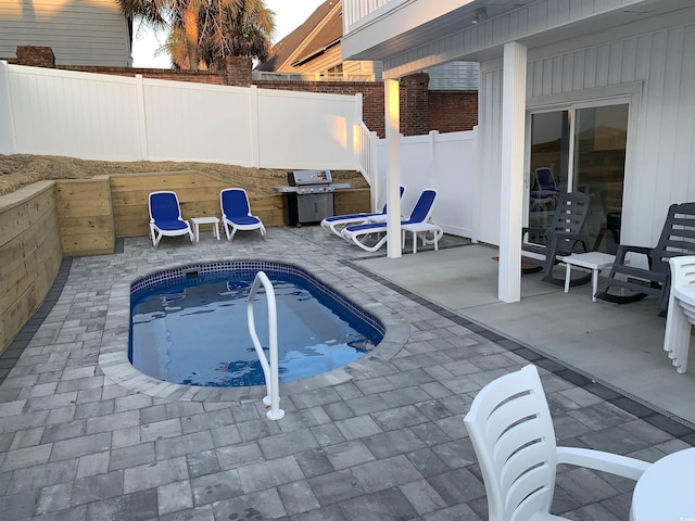 view of swimming pool featuring a fenced backyard, a patio area, and a fenced in pool