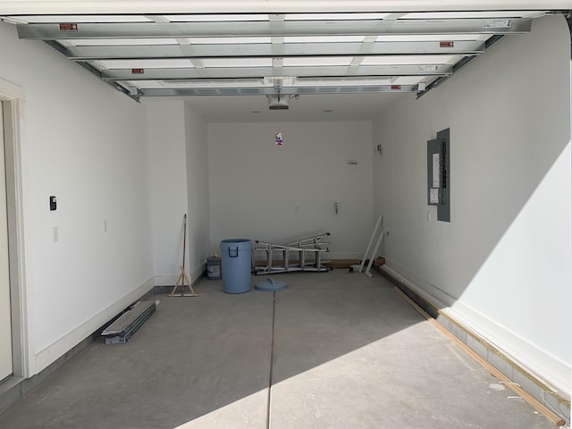 garage featuring electric panel and a garage door opener