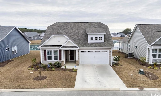 view of front of home featuring central AC unit, a garage, and a front yard