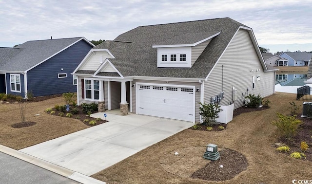 view of front of property with cooling unit and a garage