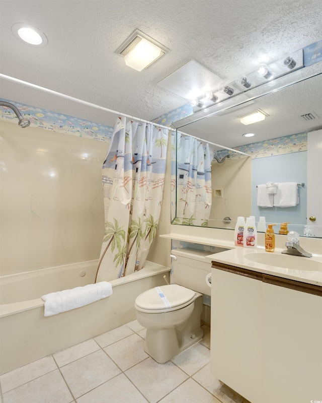 full bathroom with tile patterned floors, a textured ceiling, toilet, shower / bath combo with shower curtain, and vanity