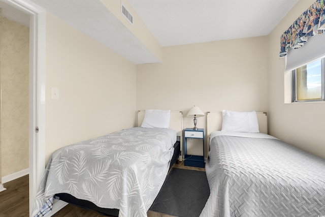 bedroom with hardwood / wood-style flooring