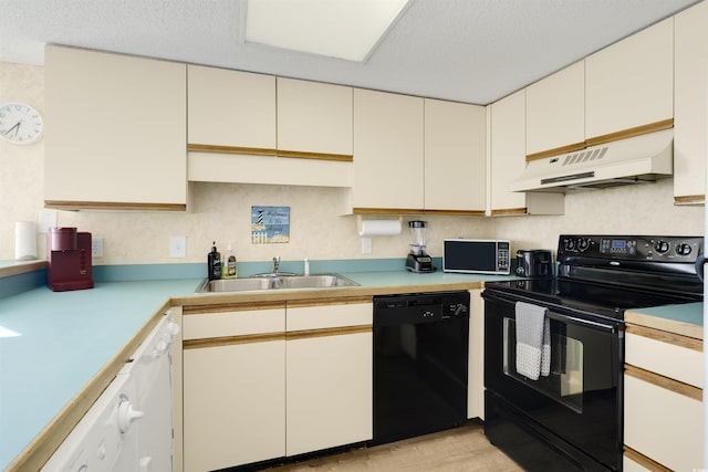 kitchen featuring black appliances, sink, and a textured ceiling