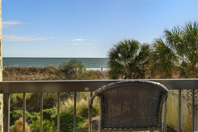 balcony with a water view and a beach view