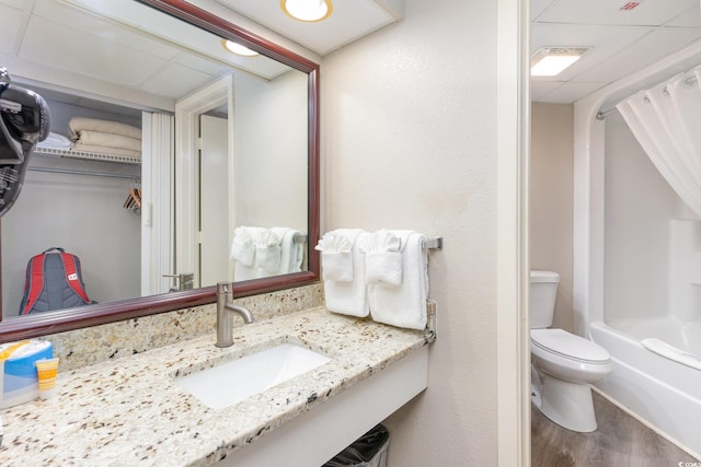 full bathroom featuring hardwood / wood-style floors, bathing tub / shower combination, toilet, and sink