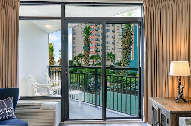 doorway to outside featuring plenty of natural light and cooling unit