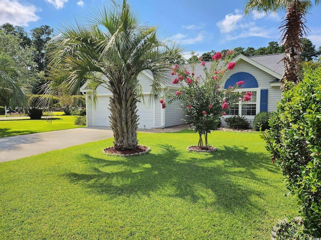 view of front of home with a garage and a front yard