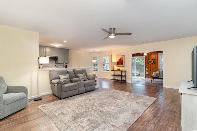 living room with hardwood / wood-style flooring and ceiling fan