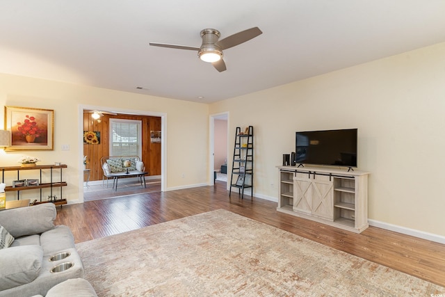 living room featuring ceiling fan and hardwood / wood-style floors