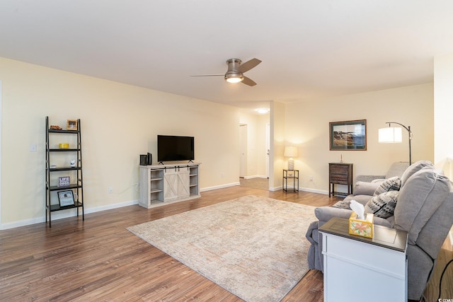 living room with hardwood / wood-style flooring and ceiling fan