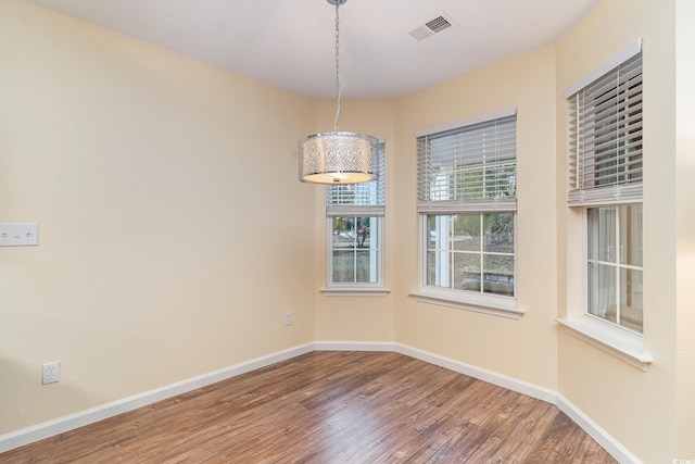 unfurnished dining area featuring hardwood / wood-style floors