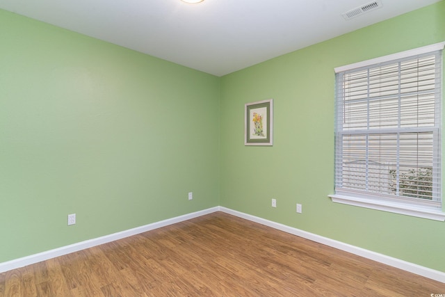 spare room with wood-type flooring