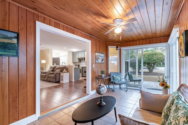 sunroom featuring sink, ceiling fan, and wood ceiling