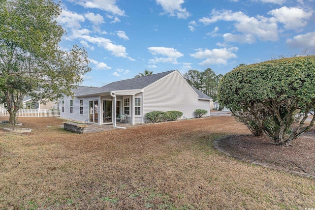 view of side of home with a lawn