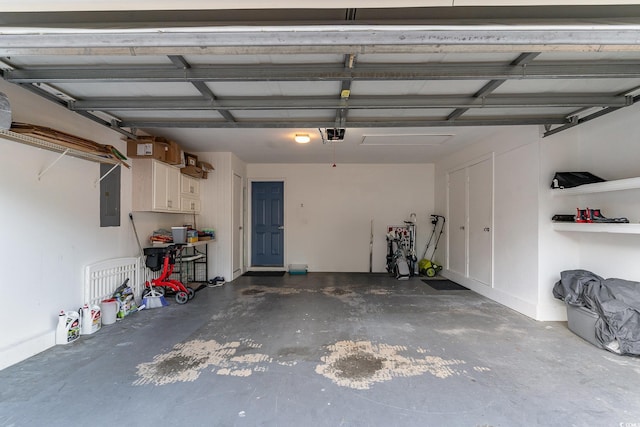 garage featuring electric panel and a garage door opener