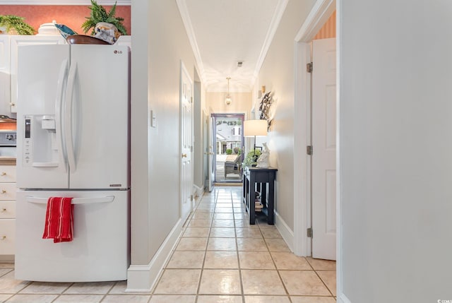 hallway featuring crown molding and light tile patterned floors