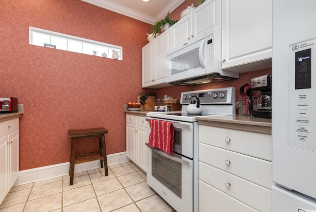 kitchen with crown molding, light tile patterned floors, white cabinets, and white appliances