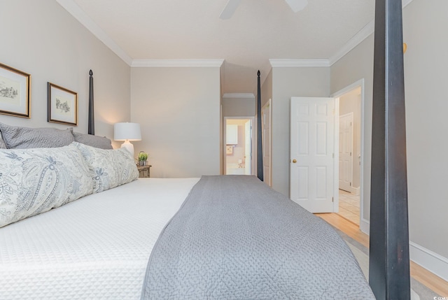 bedroom featuring ceiling fan, light hardwood / wood-style floors, crown molding, and connected bathroom