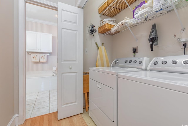 clothes washing area featuring light hardwood / wood-style flooring and independent washer and dryer