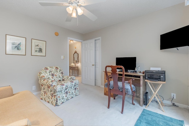 office area featuring carpet, a textured ceiling, and ceiling fan